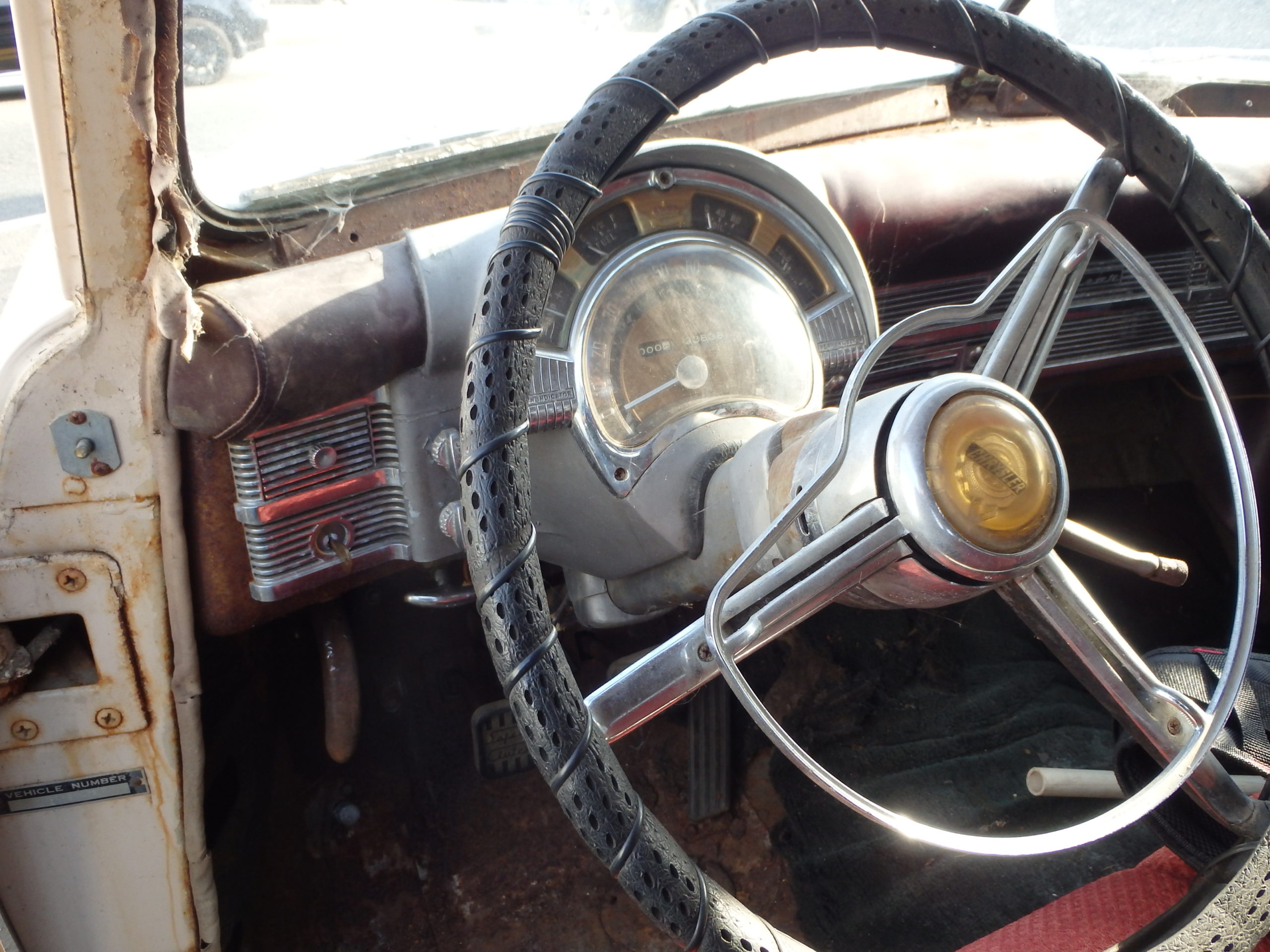 The ignition is left of the steering wheel, on the dash.